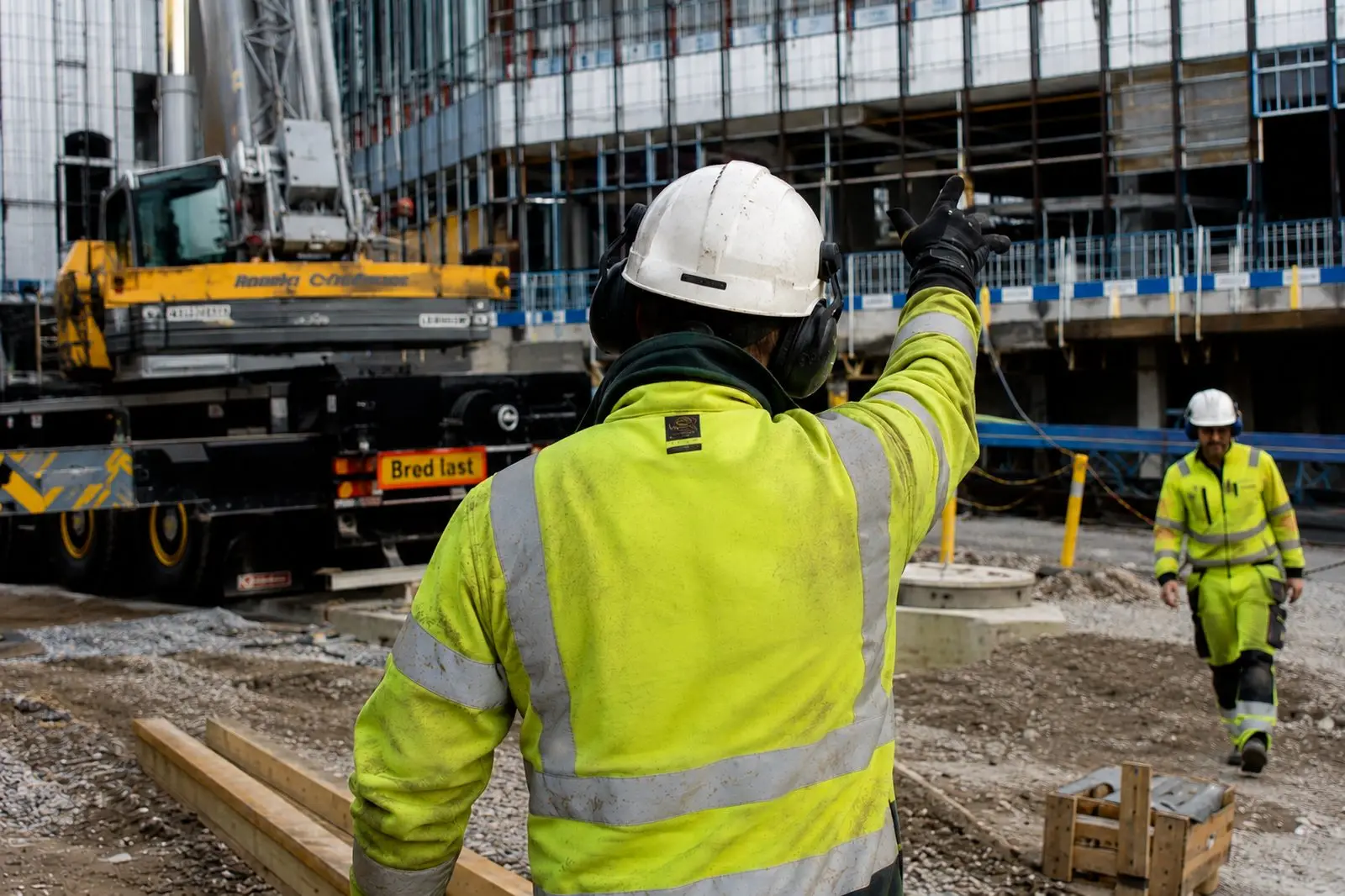 Vehicle marshal directing traffic on a construction site